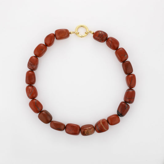 Ignite Red Jasper Necklace with organically shaped deep red jasper stones and gold-plated details on a white background.