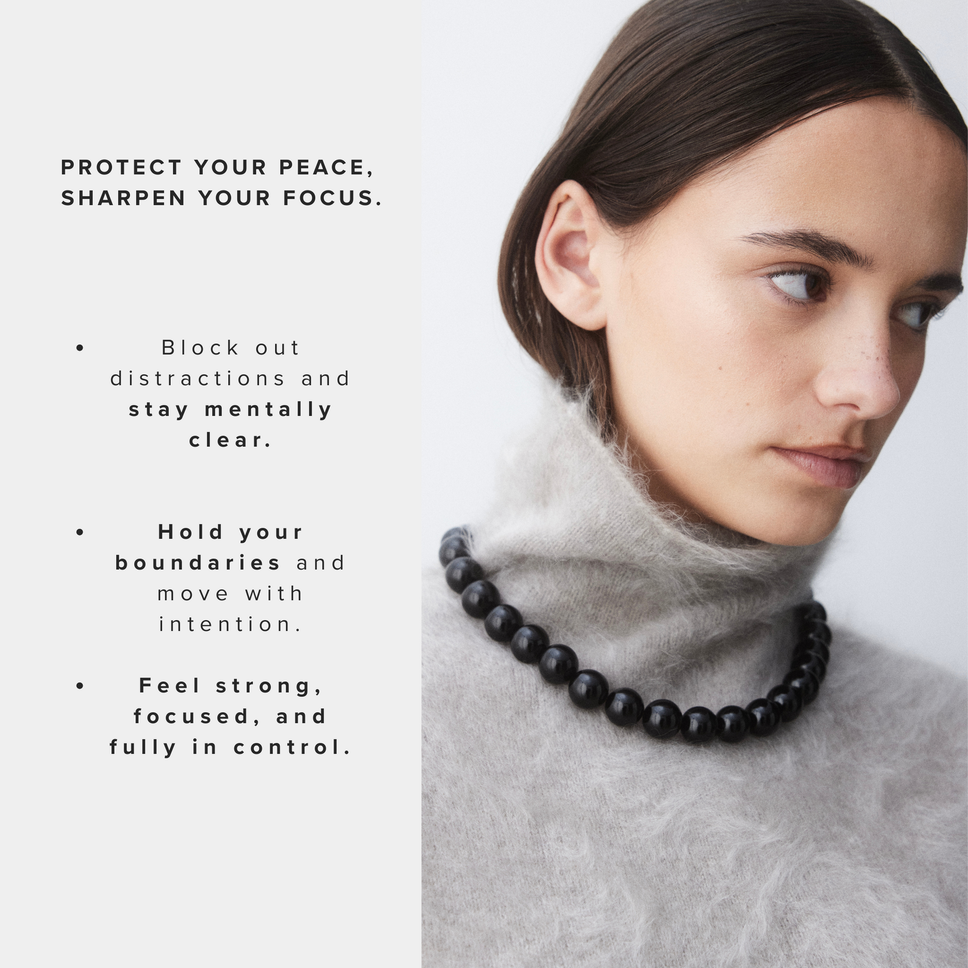 Woman wearing the Grace Black Onyx Necklace over a soft grey mohair turtleneck sweater, looking to the side with a focused expression. The black crystal beads contrast elegantly against the light knit.